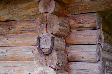 Image showing Horseshoe hang on log house corner. Luch symbol 