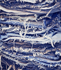 Image showing Torn jeans in stack