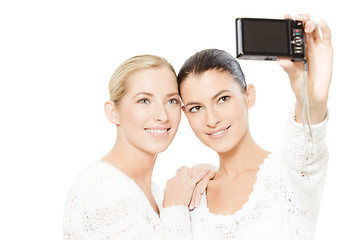 Image showing two young women taking pictures