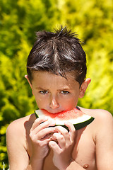 Image showing wet boy with watermelon in the garden