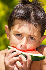 Image showing wet boy with watermelon in the garden