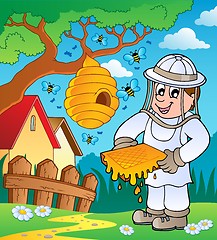 Image showing Beekeeper with hive and bees