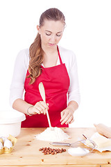 Image showing beautiful woman is baking cookies for christmas