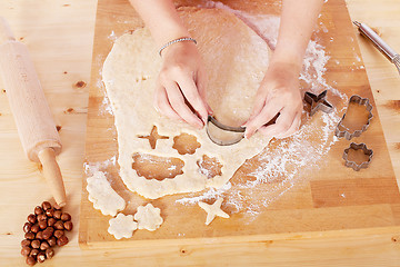 Image showing beautiful woman is baking cookies for christmas