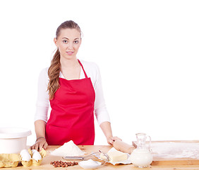 Image showing beautiful woman is baking cookies for christmas