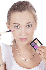 Image showing young beautiful woman applying eyeshadow on eyes