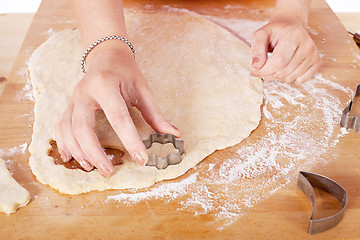 Image showing beautiful woman is baking cookies for christmas