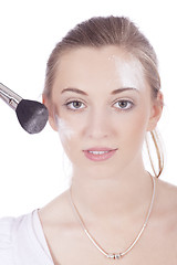 Image showing young beautiful woman applying mineral powder 