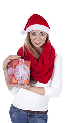 Image showing young smiling girl with red hat and present christmas