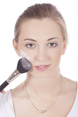 Image showing young beautiful woman applying mineral powder 