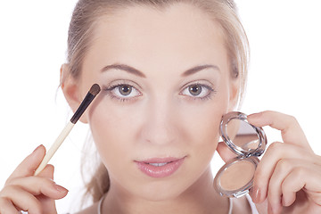 Image showing young beautiful woman applying eyeshadow on eyes