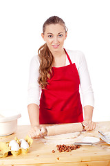 Image showing beautiful woman is baking cookies for christmas