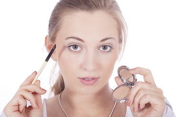 Image showing young beautiful woman applying eyeshadow on eyes