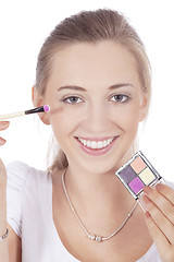 Image showing young beautiful woman applying eyeshadow on eyes