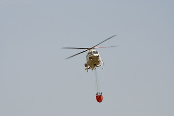 Image showing Firefighter helicopter carrying a water bucket