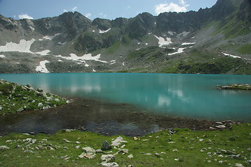 Image showing Lake in mountains. Alpine latitudes at different times of the ye