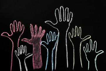 Image showing Happy volunteering hands on a blackboard background