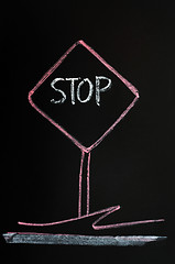 Image showing Stop warning sign drawn on a blackboard background