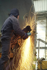 Image showing Man working with angle grinder