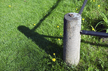 Image showing Closeup of concrete fence pole and shadows meadow 