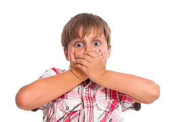 Image showing Boy covering his mouth and looking very shocked 