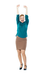 Image showing Joyful corporate woman posing with raised arms