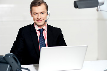 Image showing Call centre executive posing with headsets