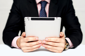 Image showing Businessman's hands holding portable device