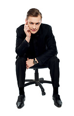 Image showing Handsome young caucasian male sitting on chair