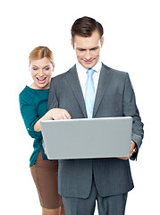 Image showing Smiling business people using laptop