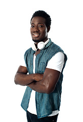 Image showing Man standing with headphones around his neck