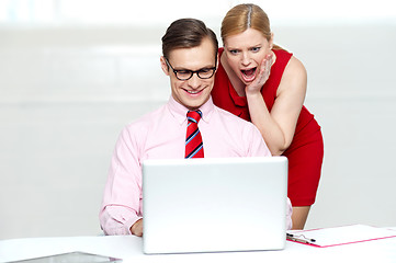 Image showing Shocked woman looking into laptop. Man working