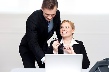 Image showing Business people at work. Male pointing at laptop