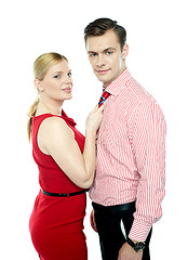 Image showing Woman grabbing man from his tie