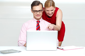 Image showing Lady pointing at something funny in laptop