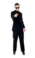 Image showing Man in party wear attire pointing at camera