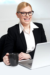 Image showing Attractive female holding black coffee cup