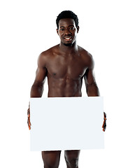 Image showing Naked black man holding blank billboard