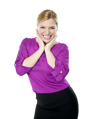 Image showing Excited woman posing with hands on chin