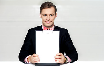 Image showing Corporate man showing blank clipboard