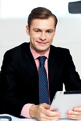 Image showing Young executive posing with tablet pc