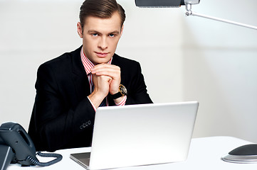 Image showing Businessman sitting in front of laptop