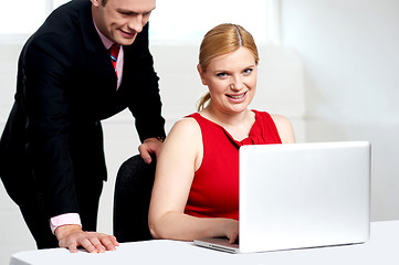 Image showing Trendy female boss working with man assisting