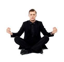 Image showing Smart young man in party wear doing yoga