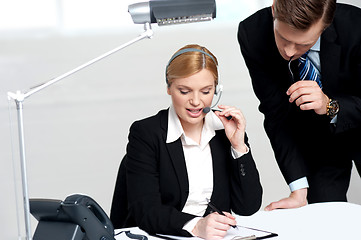 Image showing Woman discussing problem with male colleague