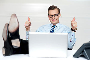 Image showing Relaxed businessman gesturing thumbs up