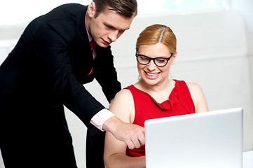 Image showing Business team in action. Man pointing at laptop