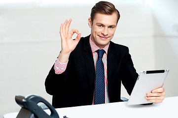 Image showing Smiling corporate male showing ok sign