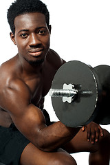 Image showing Powerful young man lifting weights