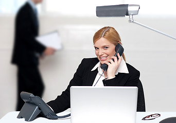 Image showing Attractive secretary attending phone call